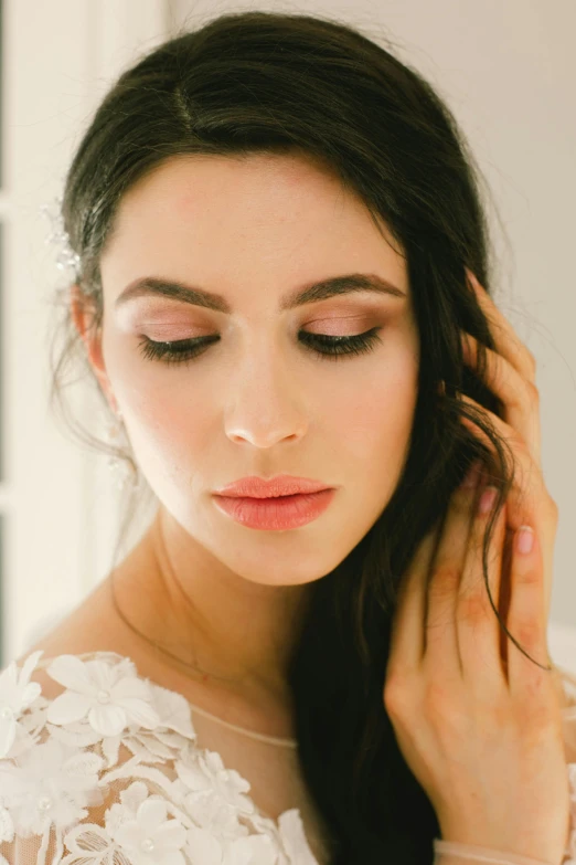 a woman with long hair wearing a wedding dress, wearing eye shadow, hand on cheek, close up subtle shadows, seraphine