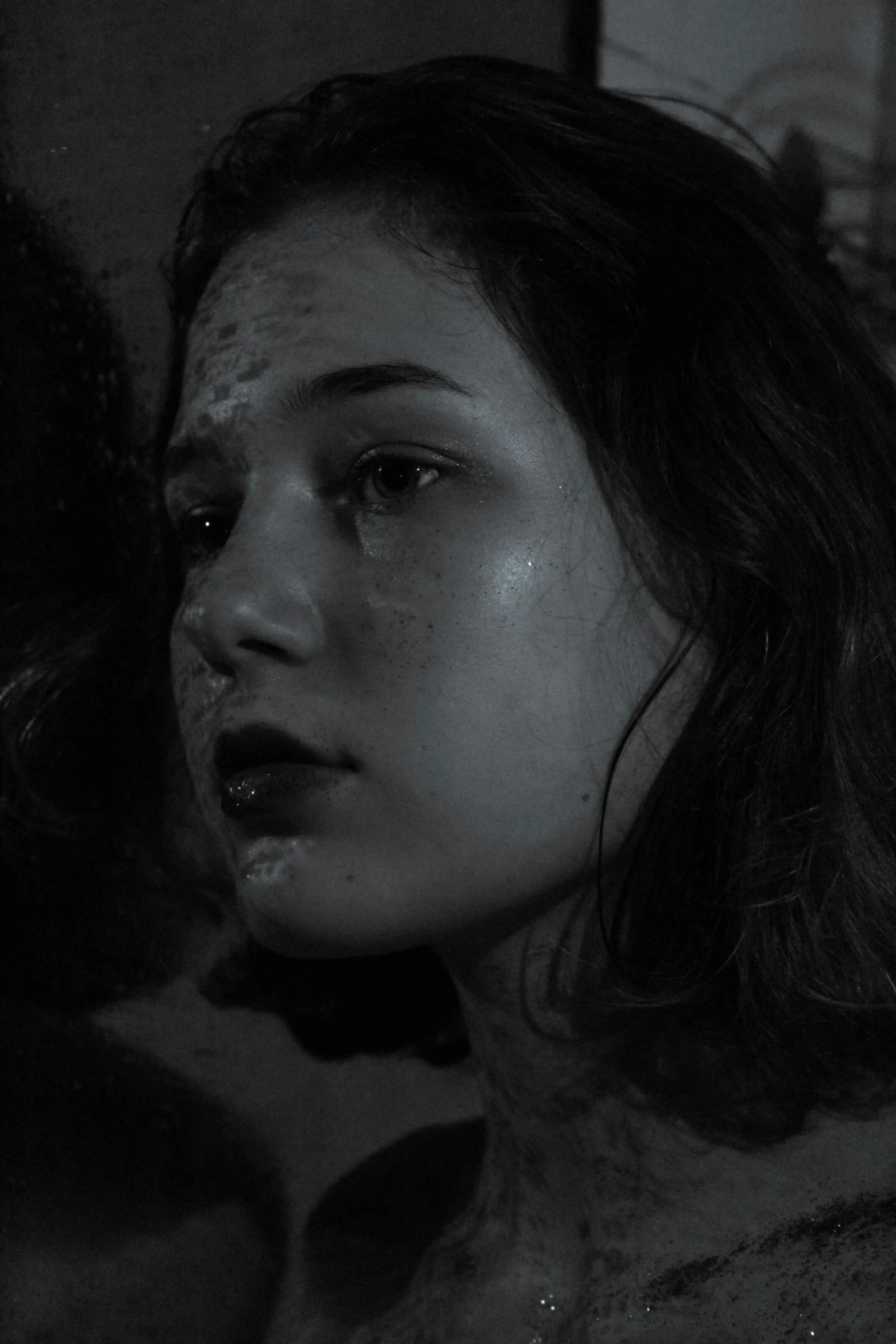 a black and white photo of a woman with blood on her face, inspired by Roy DeCarava, tumblr, realism, 2 0 2 1 cinematic 4 k framegrab, teenage girl, sansa, shy looking down