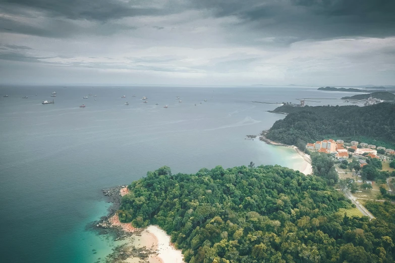 a small island in the middle of a body of water, pexels contest winner, sumatraism, the emerald coast, ships, overcast skies, manly