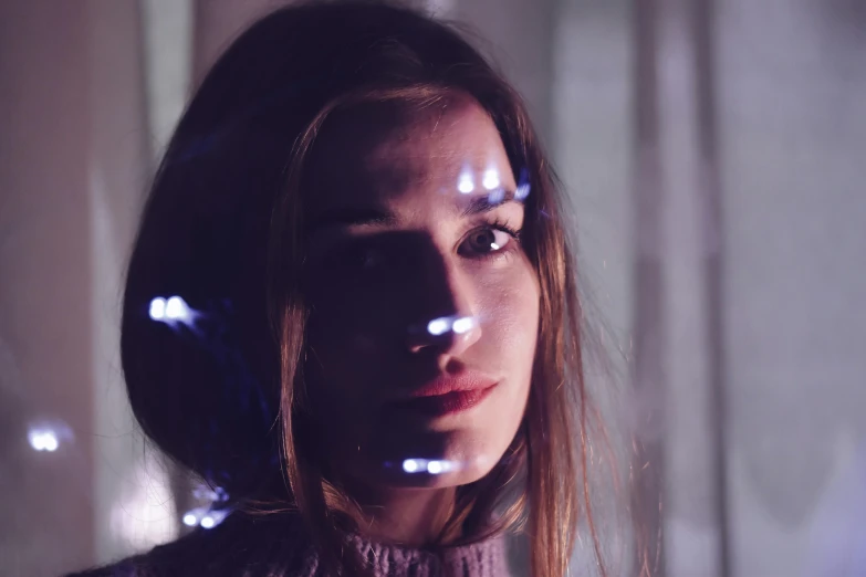 a close up of a person with headphones on, a hologram, inspired by Elsa Bleda, pexels contest winner, portrait of ana de armas, infinity mirror, light stubble, girl under lantern