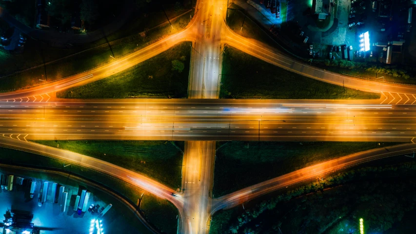 an aerial view of a highway intersection at night, by Adam Marczyński, pexels contest winner, conceptual art, thumbnail, multiple stories, vibrant and vivid, post-processed