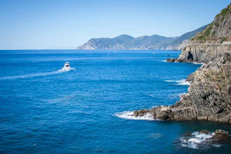 a boat in the middle of a body of water, by Giuseppe Avanzi, pexels contest winner, renaissance, picton blue, coastal cliffs, on a sunny day, thumbnail