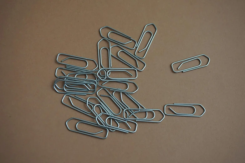 a pile of paper clips sitting on top of a table, by David Simpson, unsplash, process art, small elongated planes, ultra realist, large chain, computer wallpaper