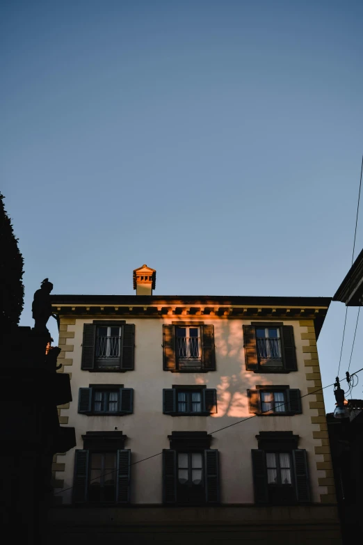 a tall building with a clock on top of it, a statue, pexels contest winner, renaissance, sunset backlight, french village exterior, swiss architecture, light from top right