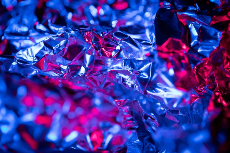 a close up of tin foil with red and blue lights, by Julia Pishtar, blue and pink shift, color ( sony a 7 r iv, purple crystals, ultramarine metal