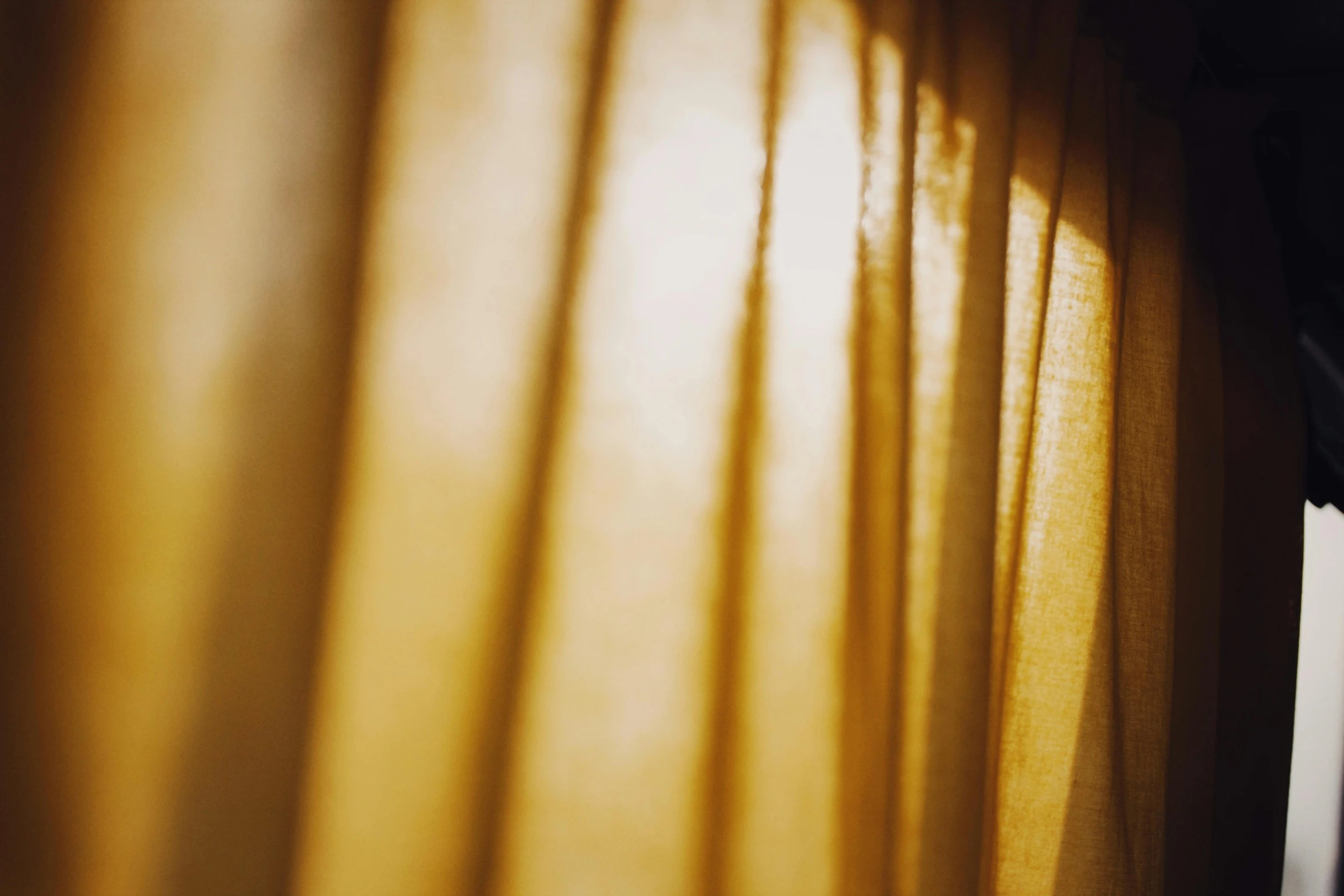 a close up of a curtain in front of a window, a picture, inspired by Elsa Bleda, unsplash, visual art, rays of golden sunlight, gold linens, journalism photo, instagram post