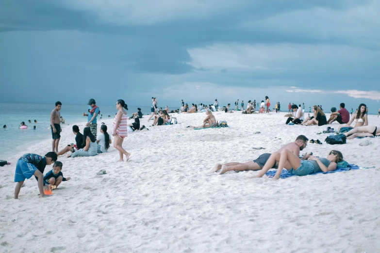 a group of people laying on top of a sandy beach, pexels contest winner, hyperrealism, south beach colors, malaysian, 2 0 0 0's photo, busy crowds