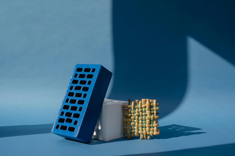 a stack of waffles sitting on top of a blue table, an album cover, conceptual art, speakers, 3d printed building, perforated metal, medium blue