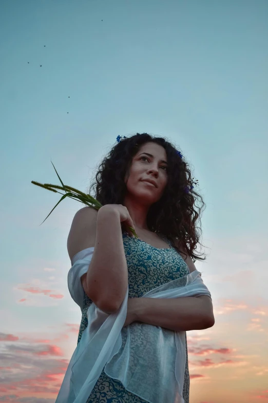 a woman standing on top of a lush green field, an album cover, unsplash, renaissance, beautiful mexican woman, at twilight, sitting on a curly branch, ((portrait))