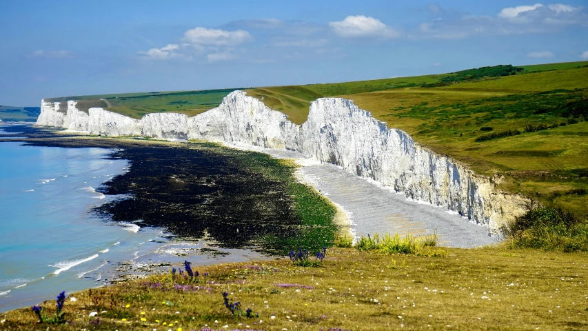 a number of white cliffs near a body of water, by Rachel Reckitt, pexels contest winner, renaissance, meadows, black, “the ultimate gigachad, icon