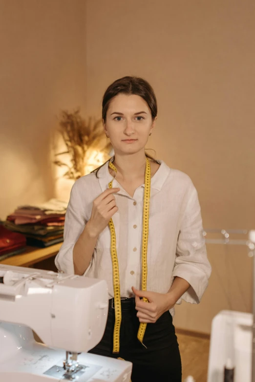 a woman standing in front of a sewing machine