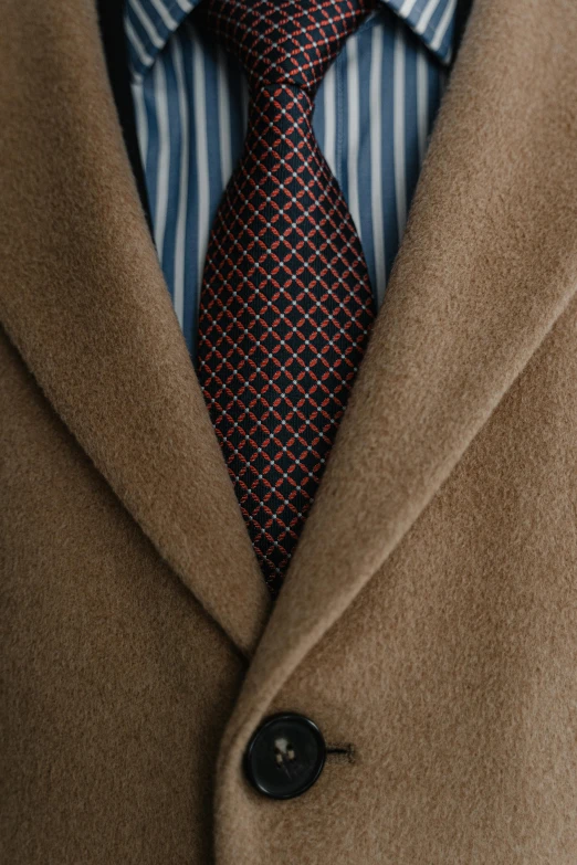 a close up of a person wearing a suit and tie, inspired by Alexander Mann, renaissance, light brown coat, brown red blue, detailed product shot, fully symmetrical