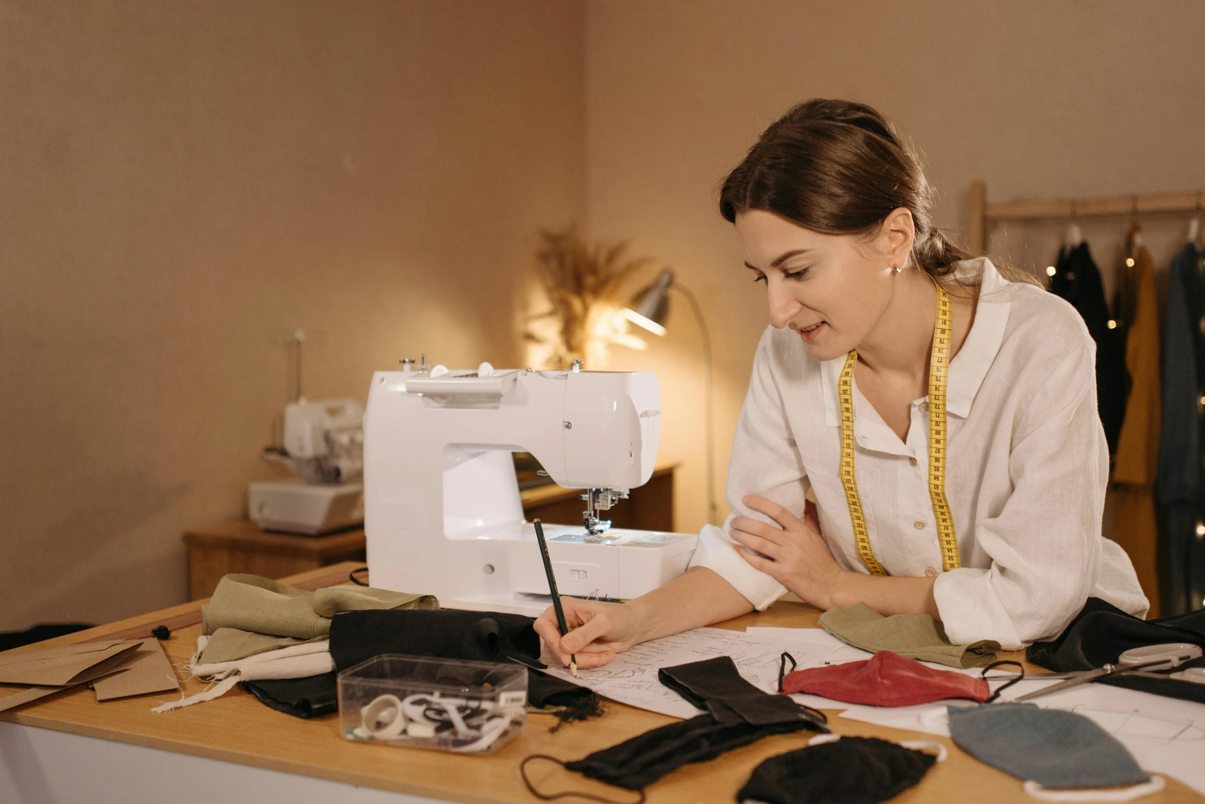 a woman sitting at a table working on a sewing machine, profile image, fancy clothing, sharpie, thumbnail