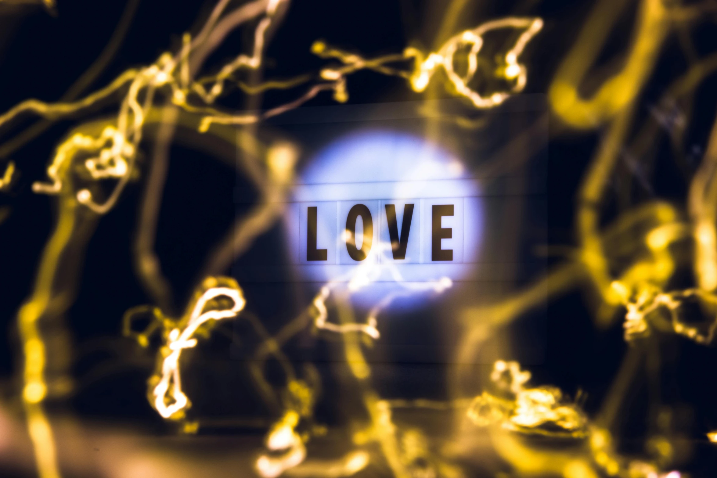 a blurry photo of the word love, by Bradley Walker Tomlin, large electrical gold sparks, ambient light background, souls, exclusive