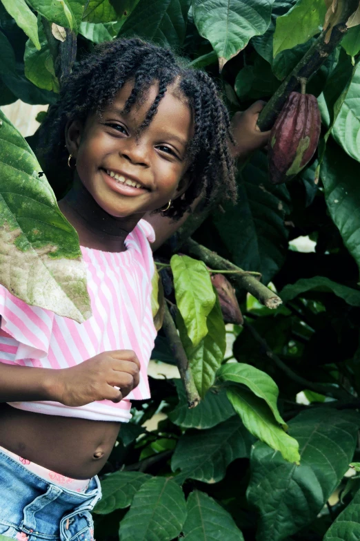 a little girl that is standing in front of a tree, jamaican, organics, header, thumbnail