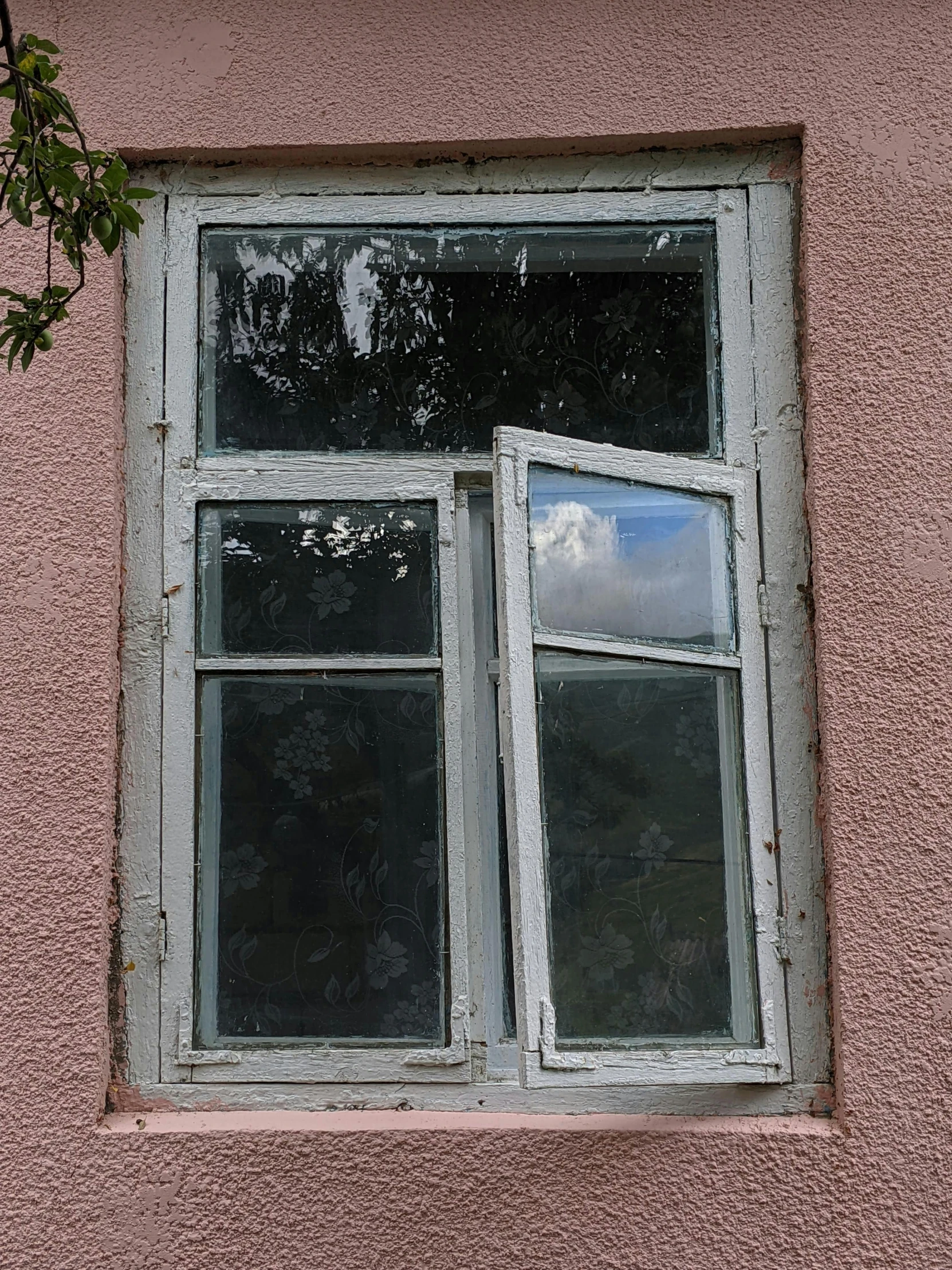 a close up of a window on a pink building, by Attila Meszlenyi, with a whitish, ukraine. photography, repairing the other one, vinyl on glazing