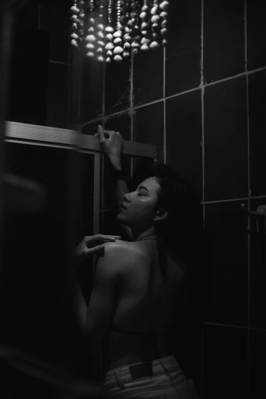 a black and white photo of a woman in a bathroom, inspired by Elsa Bleda, night time footage, by :5 sexy: 7, cinematic. by leng jun, showers