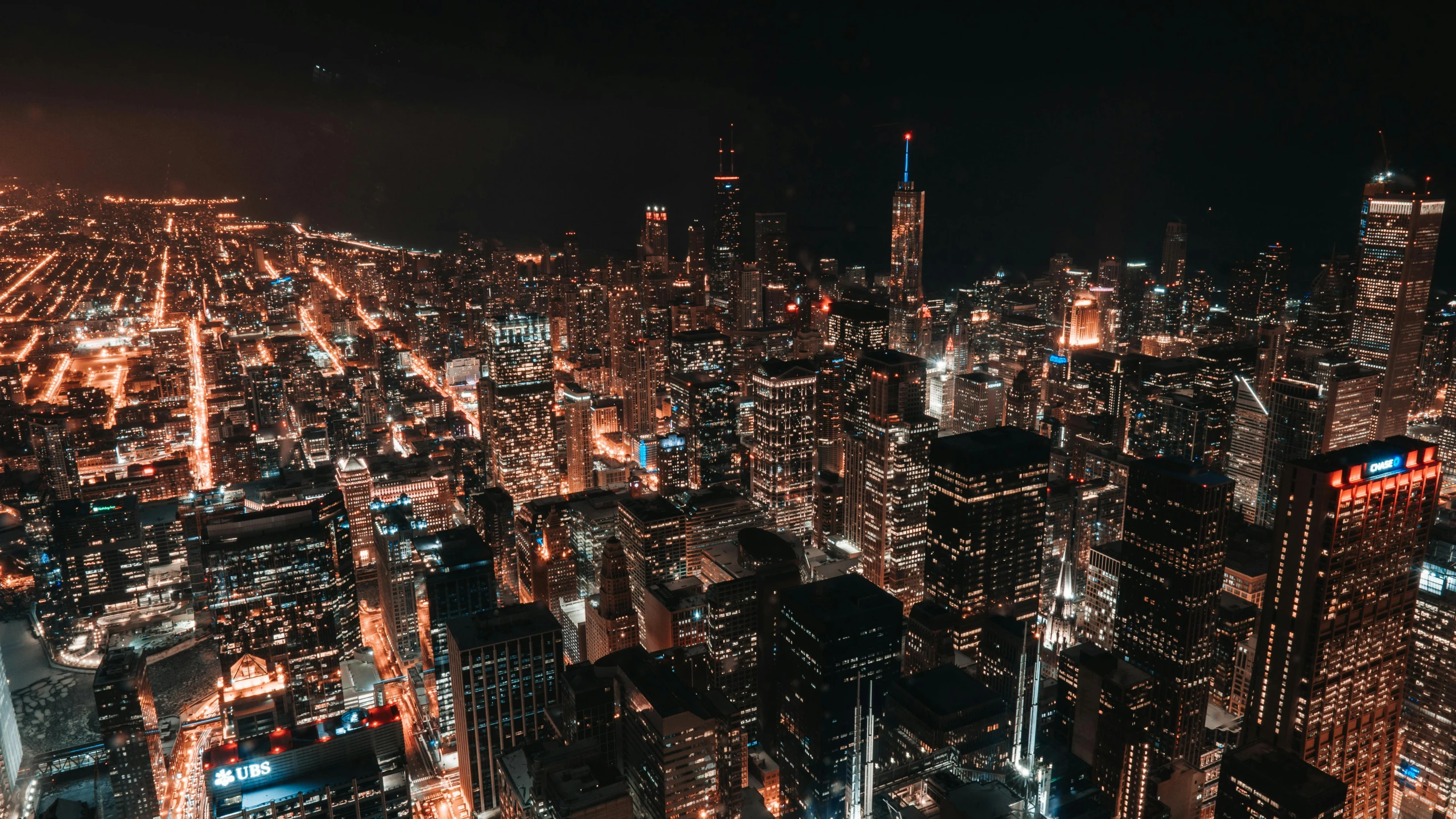 an aerial view of a city at night, pexels contest winner, chicago, rooftop party, background image