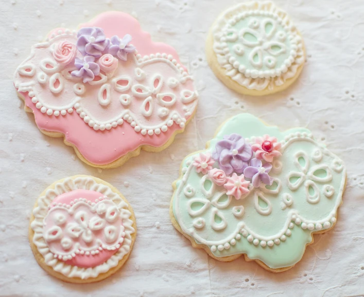 a group of decorated cookies sitting on top of a table, a pastel, inspired by Margaret Brundage, pexels, arabesque, victorian lace, retro style ”, february)