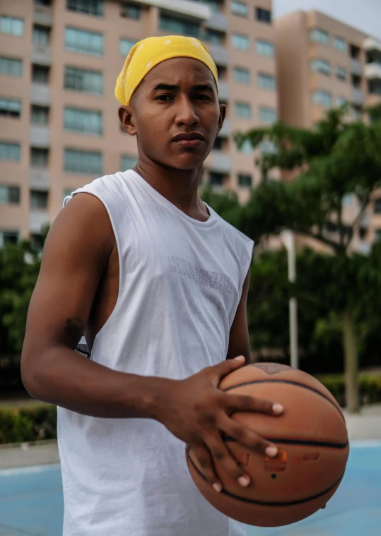 a man holding a basketball on top of a basketball court, peruvian looking, profile image, large)}], street photo