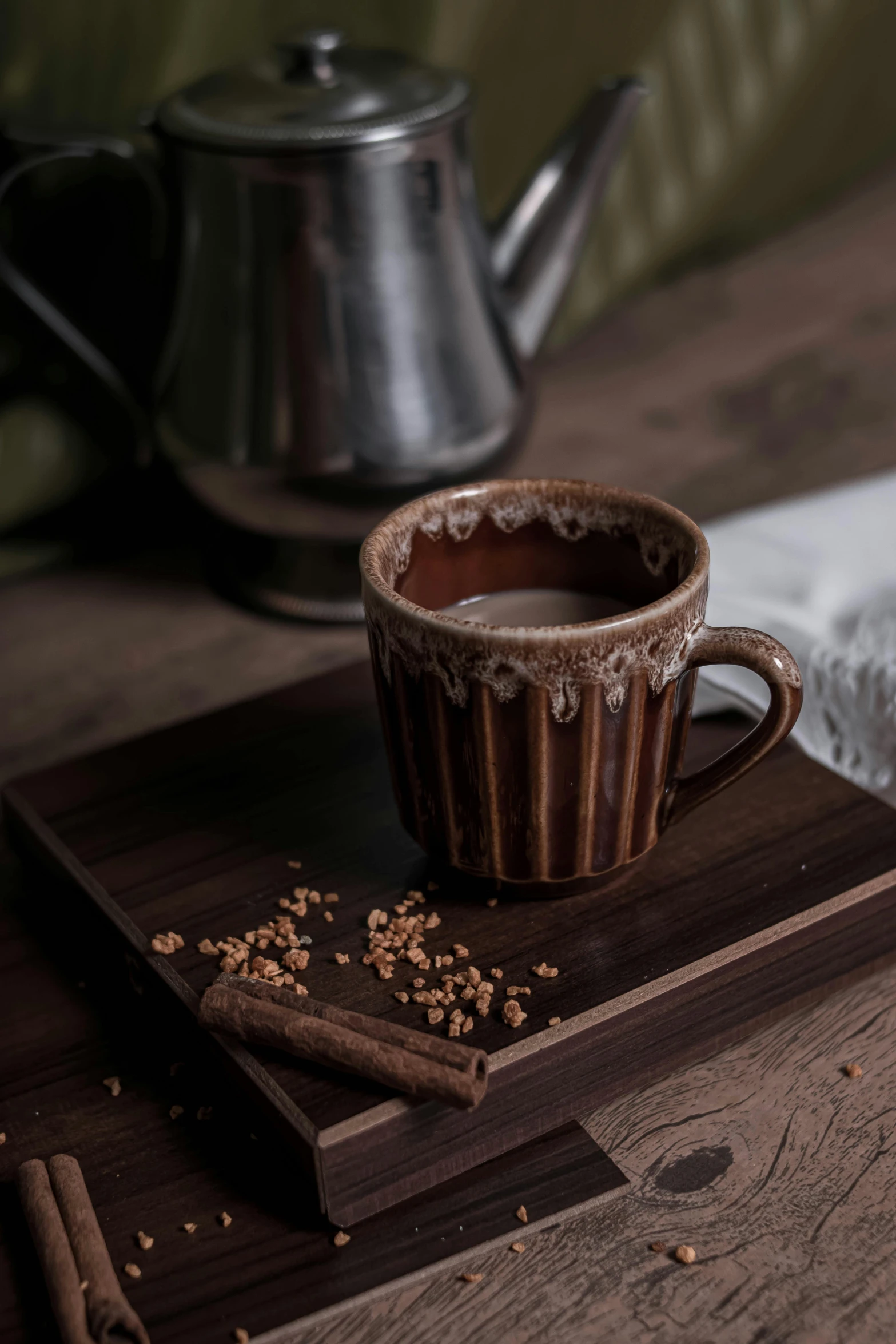 a cup of coffee sitting on top of a wooden tray, inspired by Muggur, renaissance, chocolate. rugged, square, thumbnail, malaysian