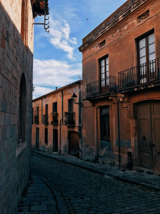 a cobblestone street in an old european city, inspired by Luis Paret y Alcazar, pexels contest winner, overlooking, bartolome ros, gif, deserted