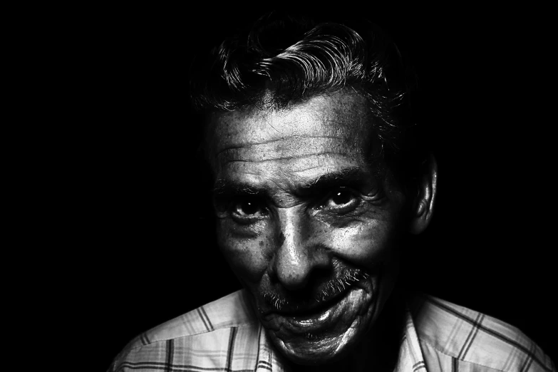 a black and white photo of a man making a funny face, inspired by Lee Jeffries, pexels contest winner, indian, color photograph portrait 4k, taken in the late 2000s, humanoid face