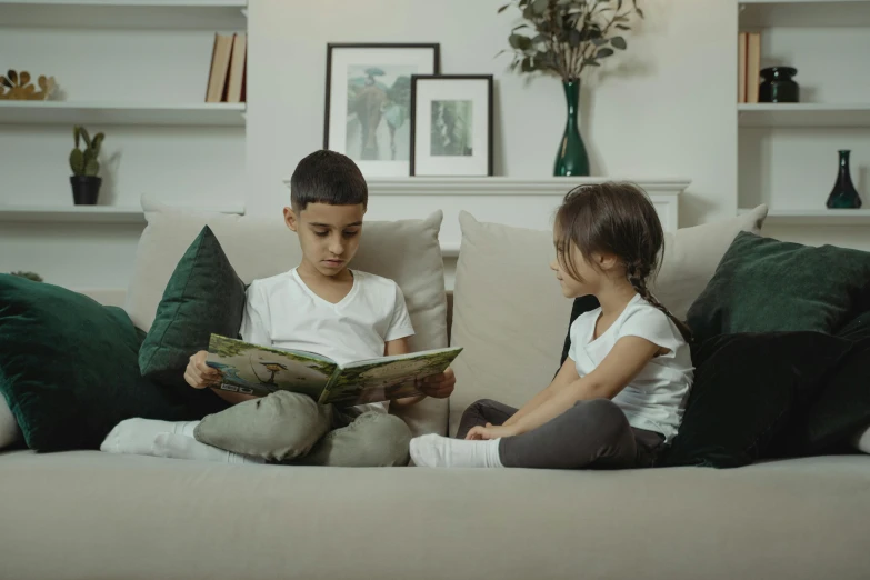 two children sitting on a couch reading a book, a cartoon, pexels contest winner, hurufiyya, low quality photo, english, furniture, 15081959 21121991 01012000 4k