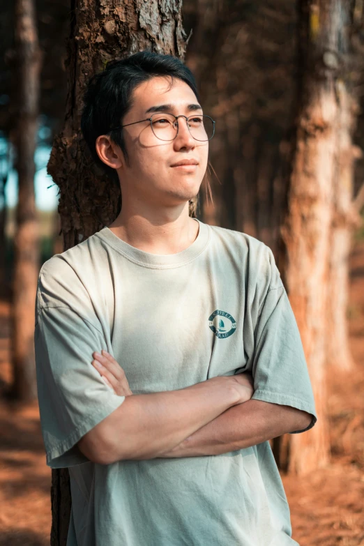 a man standing next to a tree in a forest, inspired by Yeong-Hao Han, pexels contest winner, realism, wearing a t-shirt, headshot profile picture, discord profile picture, engineer