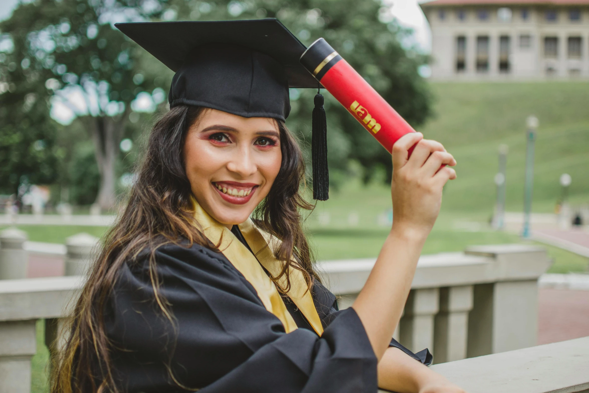 a woman in a graduation gown holding a diploma, a portrait, pexels contest winner, hispanic, black and yellow and red scheme, 🦩🪐🐞👩🏻🦳, handsome girl