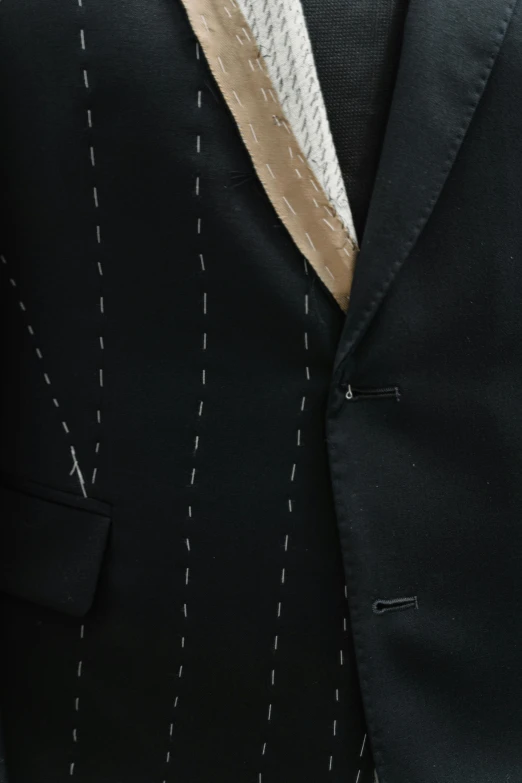 a suit and tie on a mannequin mannequin mannequin mannequin mannequin mannequin mannequin mann, inspired by Lucio Fontana, zoomed in, stitches, long black jacket, 3-piece-suit