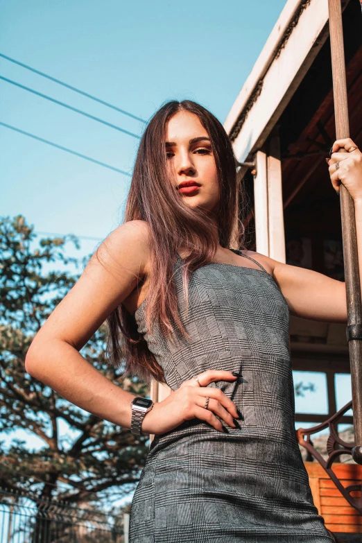 a beautiful young woman standing in front of a trolley, trending on pexels, renaissance, dua lipa, dressed in a gray, attractive photo, portait photo profile picture