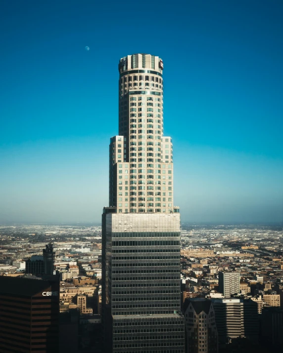 a tall building sitting in the middle of a city, on top of it, los angelos, thumbnail, minneapolis