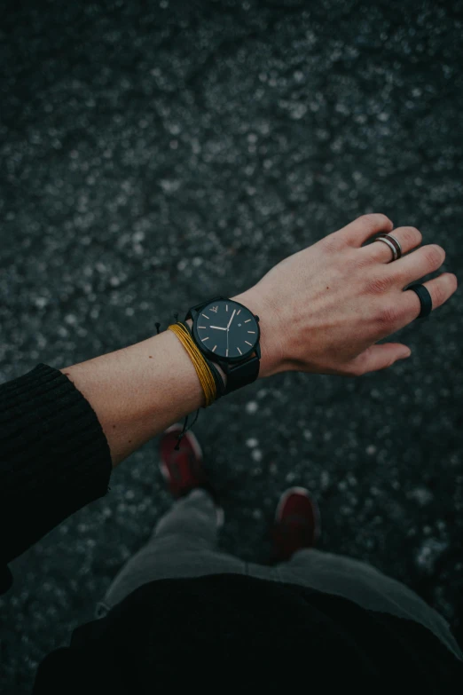 a person with a watch on their wrist, pexels contest winner, dark matte metal, yellow and charcoal leather, outdoors, ready to model