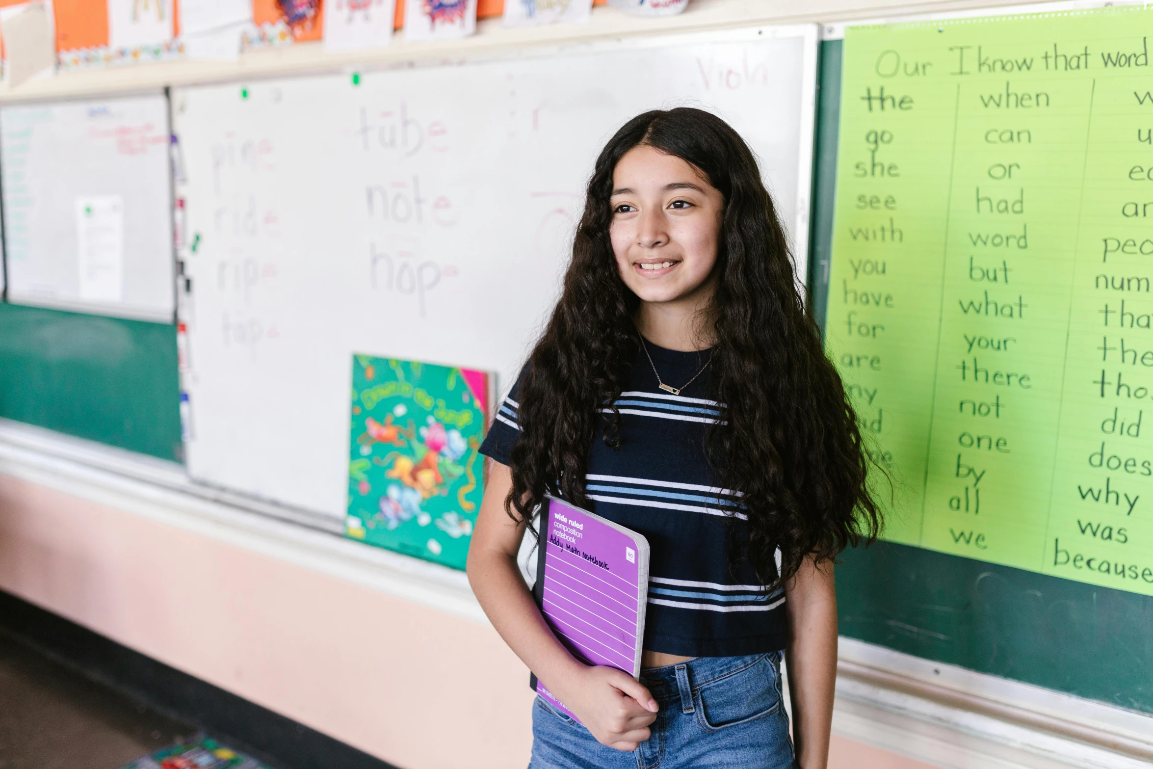 a young girl standing in front of a whiteboard, pexels contest winner, danube school, holding notebook, kailee mandel, ariel perez, standing straight