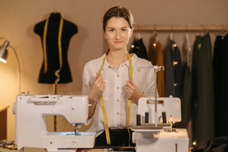a woman standing in front of a sewing machine