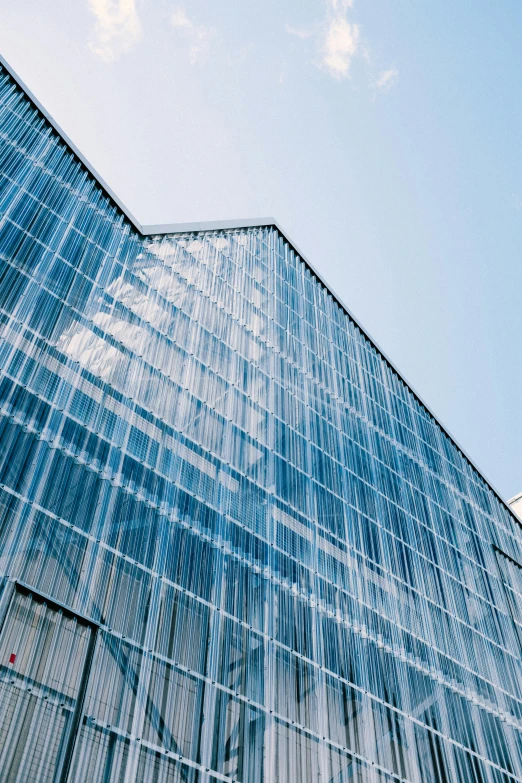 a tall glass building with a sky background, inspired by Tadao Ando, pexels contest winner, modernism, translucent pastel panels, warehouses, transparent corrugated glass, thumbnail