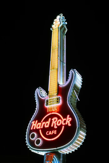 a neon guitar sign in front of a hard rock cafe, by Jesse Richards, pop art, ((rocks)), promo image, high detail photo, high rocks