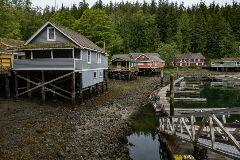 a number of houses near a body of water, by Jessie Algie, pexels contest winner, vancouver school, small port village, slide show, thumbnail, stacked image