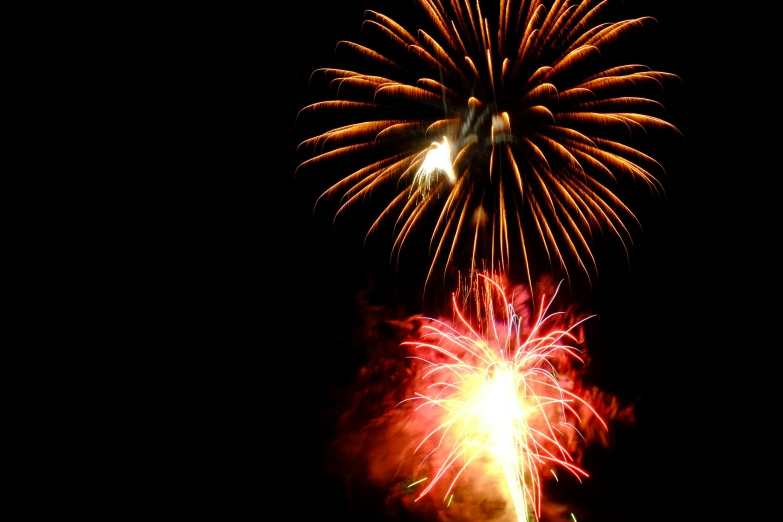 a fireworks is lit up in the night sky, a portrait, may 1 0