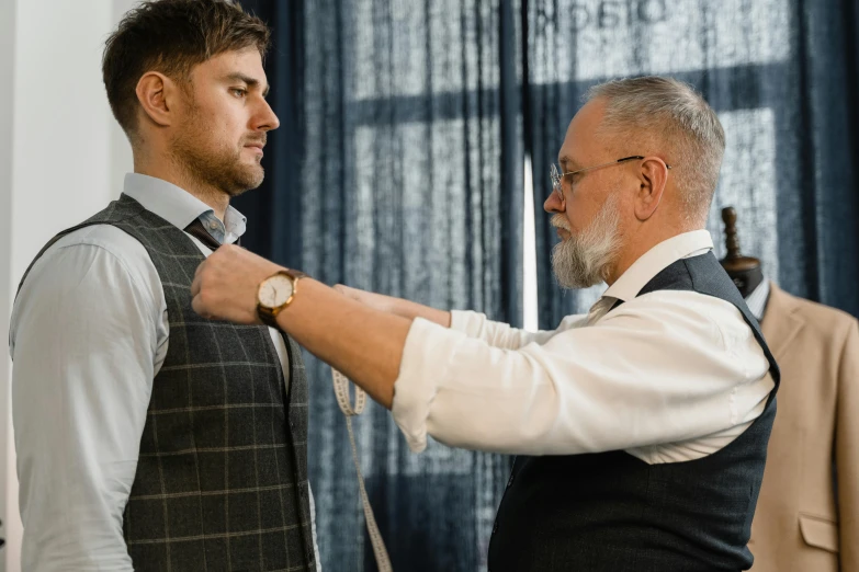 a man adjusting another man's tie in a room, pexels contest winner, body fitted dart manipulation, bearded and built, stan winston studios, thumbnail