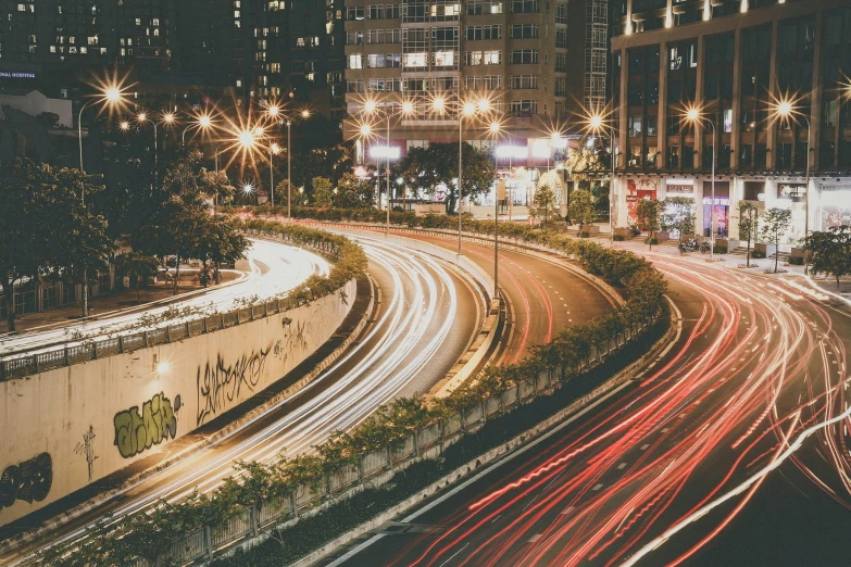 a city street filled with lots of traffic at night, pexels contest winner, curved lines, instagram picture, city like hong kong, vintage look