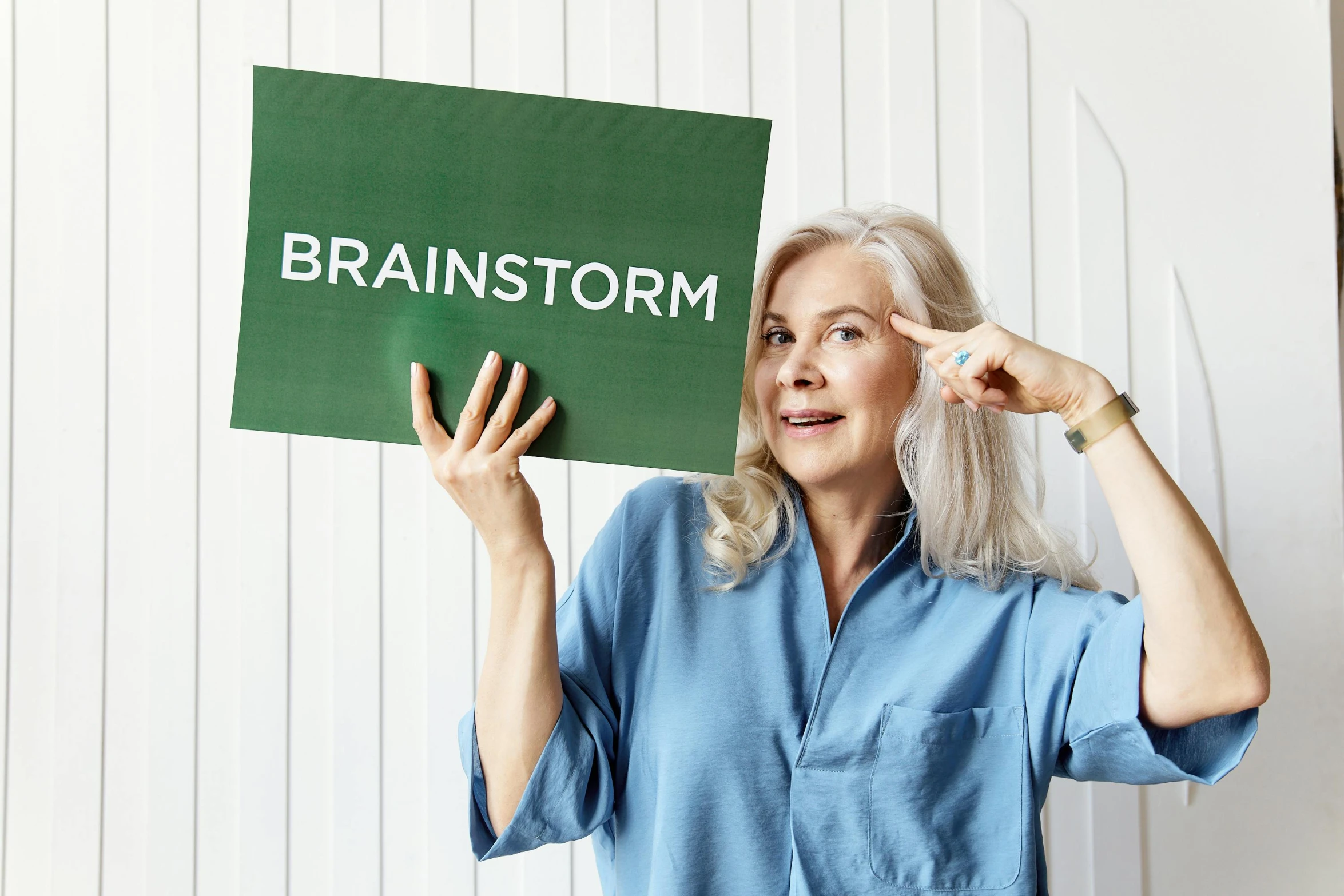 a woman holding a sign that says brainstorm, stylised storm, dementia, instagram post, billboard image