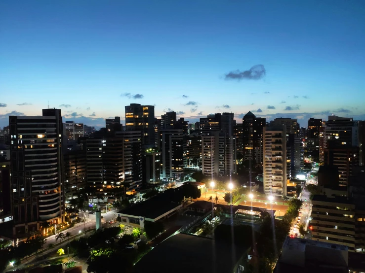 an aerial view of a city at night, by Felipe Seade, lit in a dawn light, edu souza, drone footage, skyline