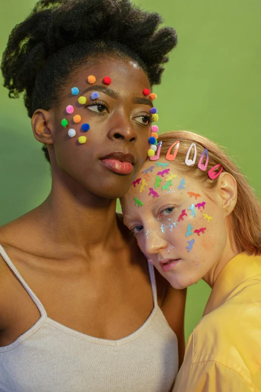 a couple of women standing next to each other, an album cover, trending on pexels, feminist art, colorful dots, facepaint, contracept, freckles