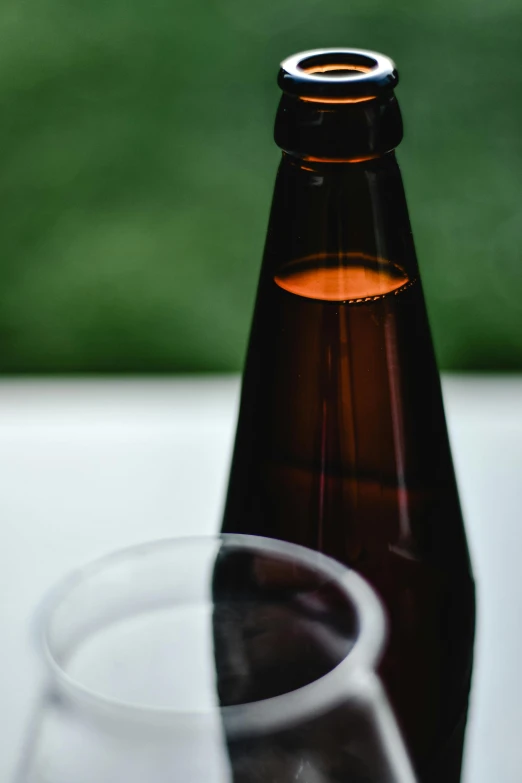 a bottle of beer and a glass on a table, by Carey Morris, unsplash, purism, liquid translucent amber, dark red, in profile, made of drink