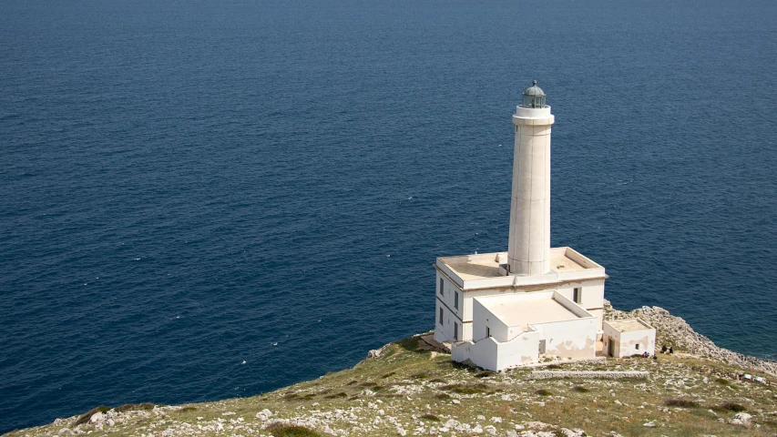 a lighthouse sitting on top of a cliff next to the ocean, inspired by Fede Galizia, les nabis, exterior photo, whitewashed housed, press release, islamic