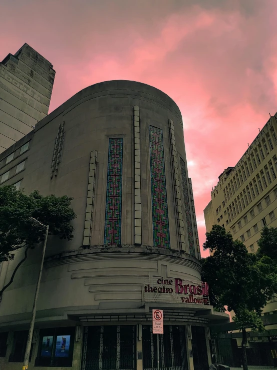 a building with a pink sky in the background, são paulo, theatrical, profile image