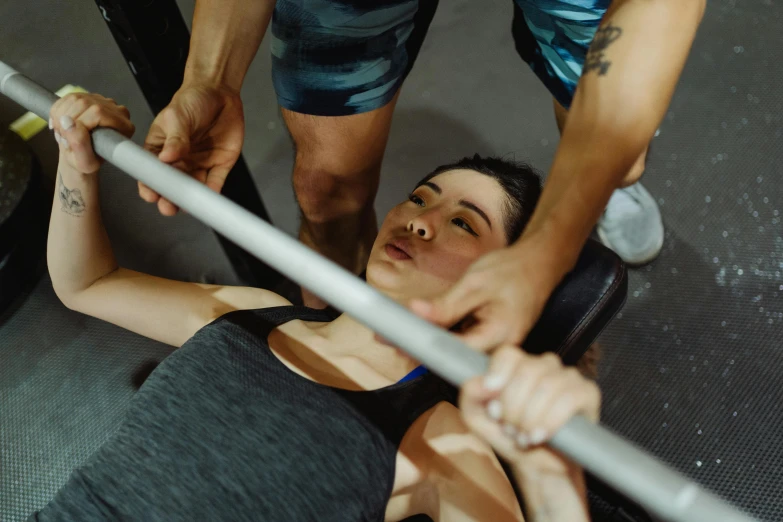 a woman lifts a barbell in a gym, pexels contest winner, head straight down, lachlan bailey, graeme base, jamie coreth