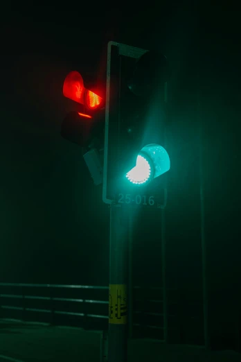 a traffic light sitting on the side of a road, an album cover, inspired by Elsa Bleda, unsplash, paul barson, red green black teal, technological lights, pareidolia